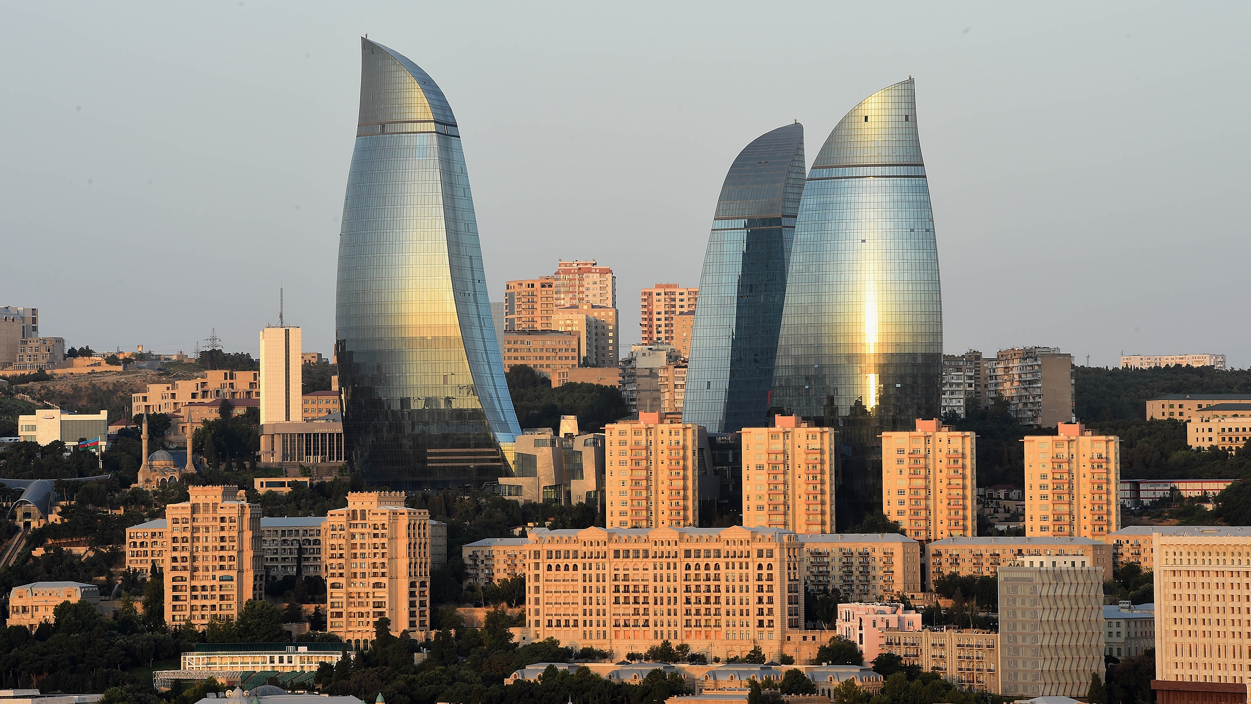 BAKU, AZERBAIJAN - AUGUST 04:  The Sun rise is reflected in The Flame Towers on August 4, 2014 in Baku, Azerbaijan.  (Photo by Christopher Lee/Getty Images)